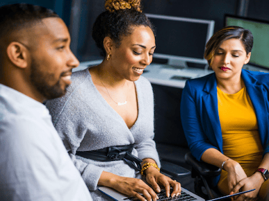 A picture of 3 people collaborating.