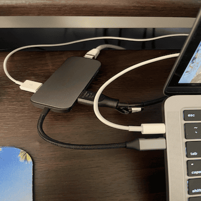 A picture of my Macbook Pro and many plugs in a dongle hub.