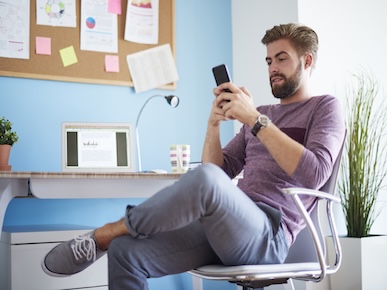 A picture of a man using his smartphone.